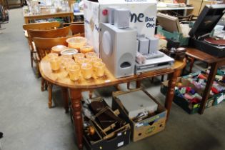 A modern pine extending kitchen table and a set of