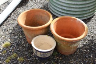 A pair of terracotta planters and one other