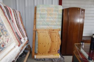 A stripped pine single bed