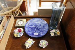 Four floral encrusted porcelain ornaments; a blue and white decorated wall plate; an onyx mounted