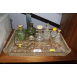 A glass dressing table tray and perfume bottles et