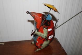 A metal ware figure of a mouse with an umbrella