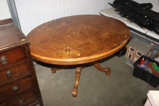 A Victorian walnut tilt top table