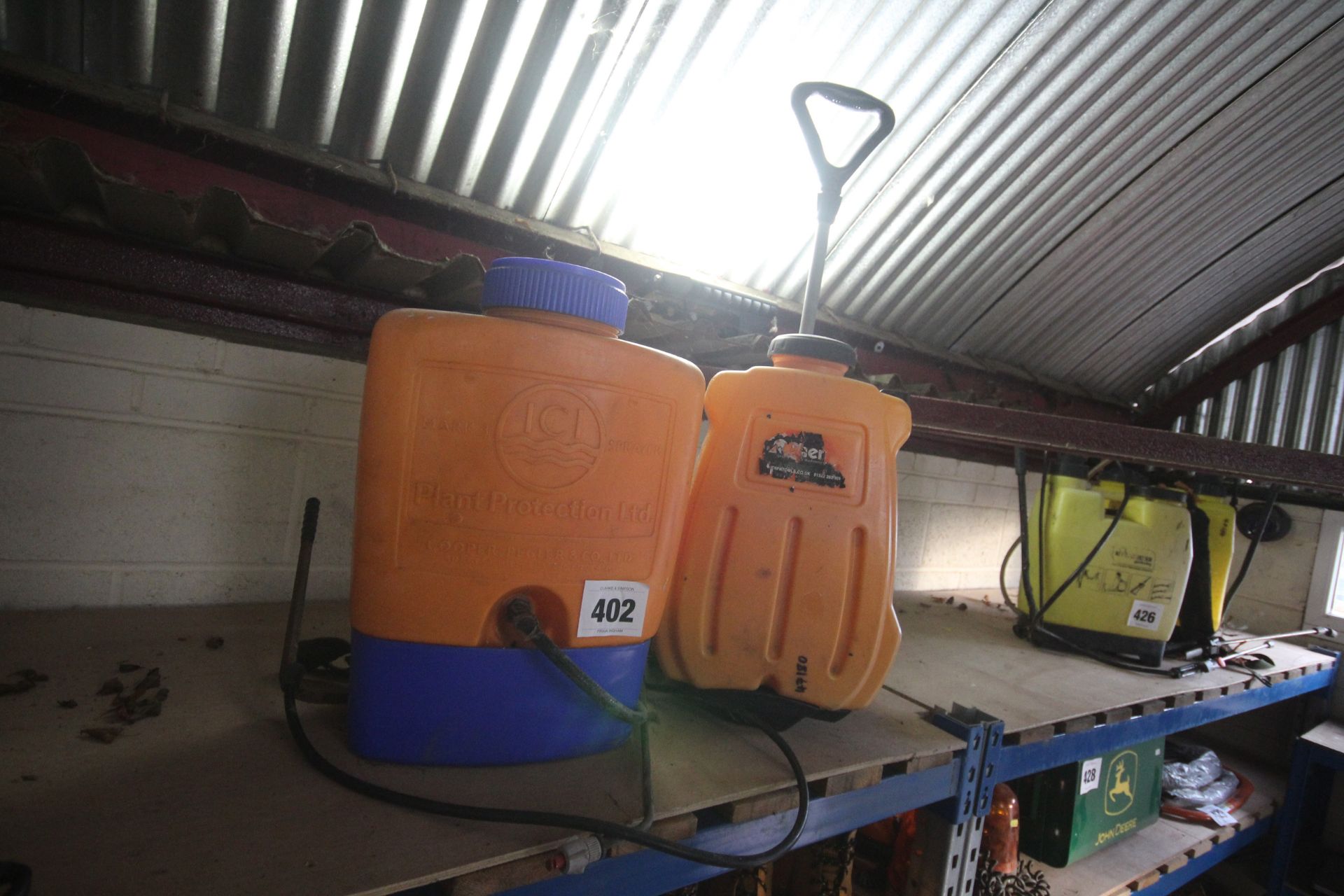 2x orange knapsack sprayer.