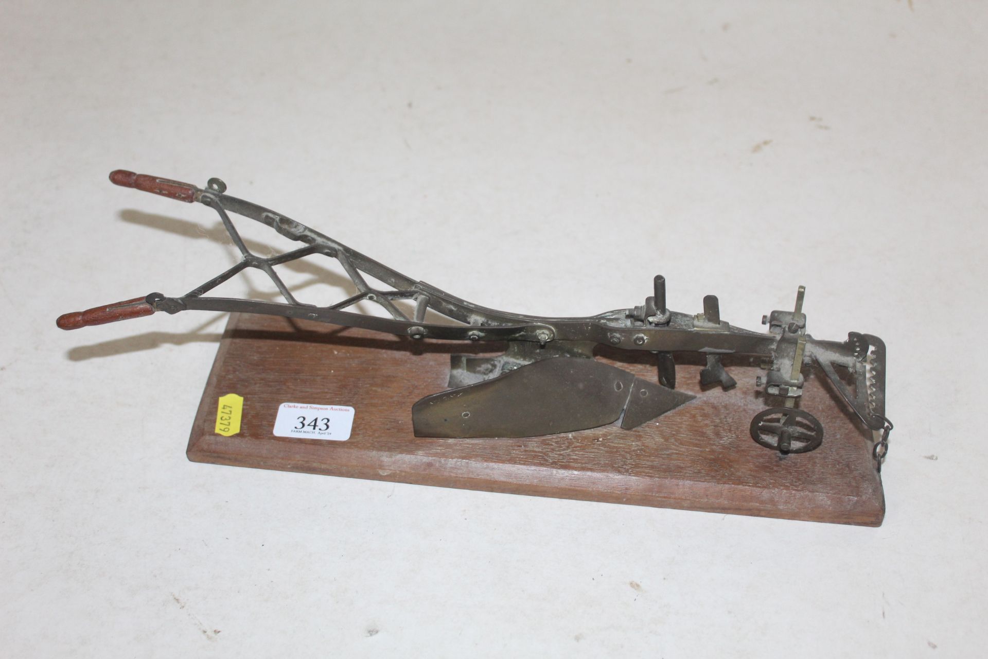 Model of a horse plough on a plinth.