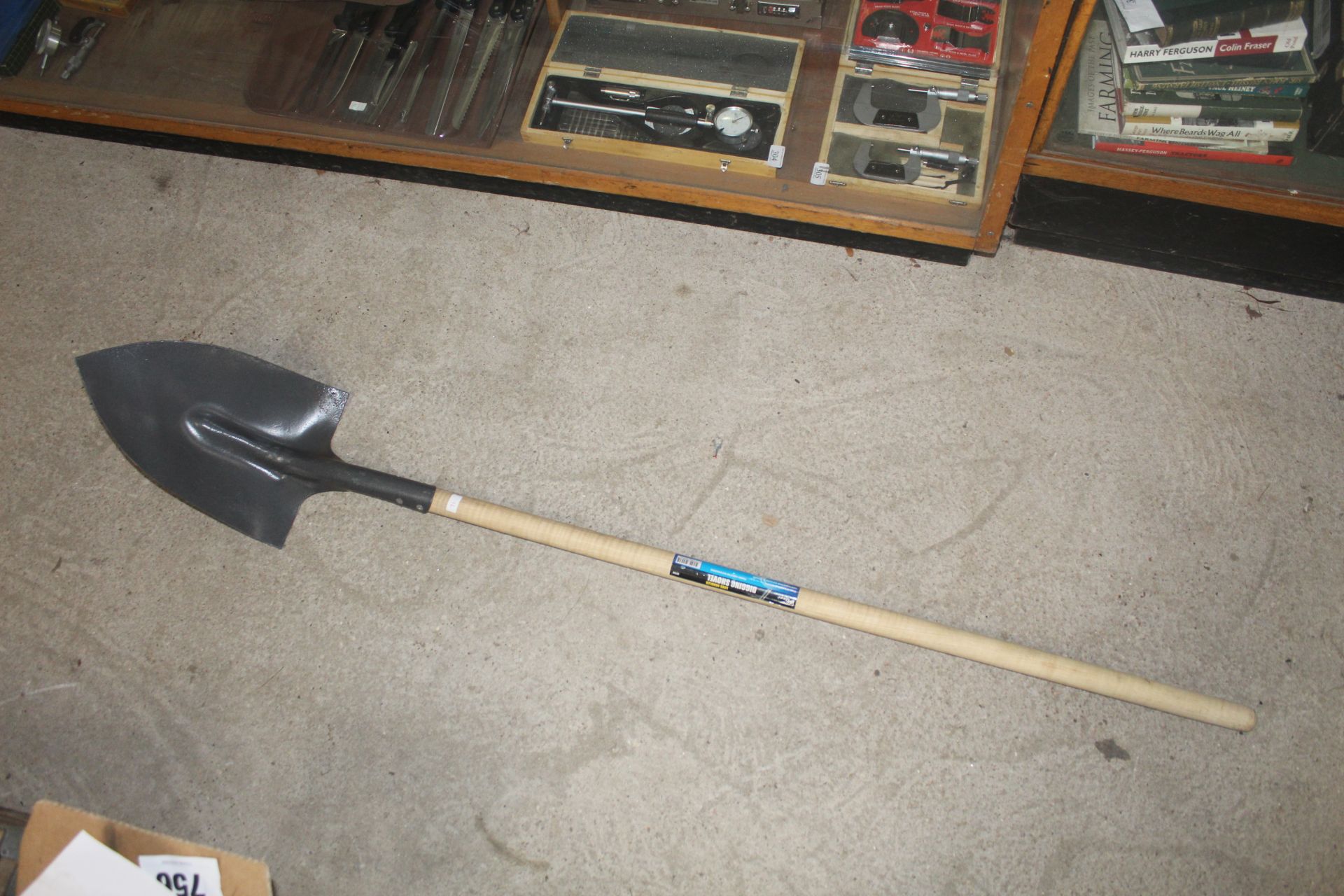 Long handled digging shovel. V