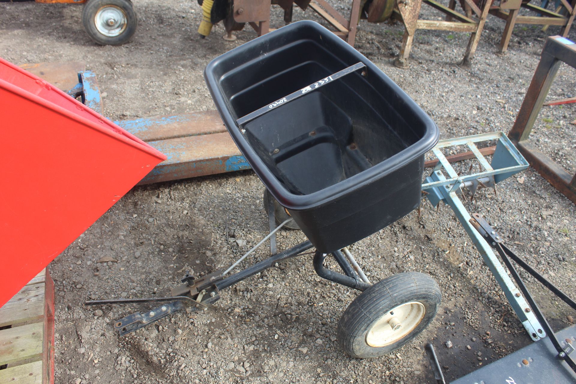 Trailed seed spreader for ride-on mower.