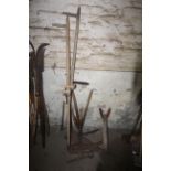 Various garden tools including scythes and shears