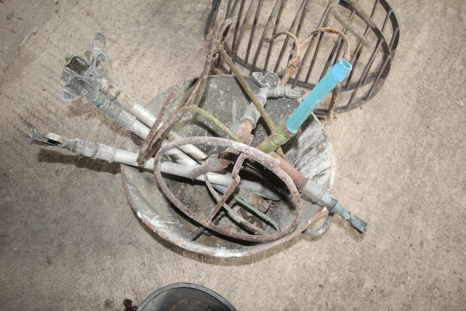 Galvanised pale containing various large sprinklers.