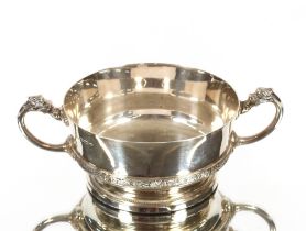 A small silver two handled bowl, by Adie Bros. with raised foliate and dragon decoration, Birmingham
