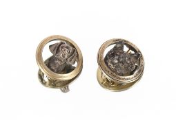 A pair of early 20th Century silver hunting brooches, depicting a hounds head and a fox head,