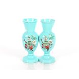 A pair of 19th Century blue opaque glass baluster vases, having enamelled decorated of flowers