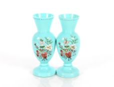 A pair of 19th Century blue opaque glass baluster vases, having enamelled decorated of flowers