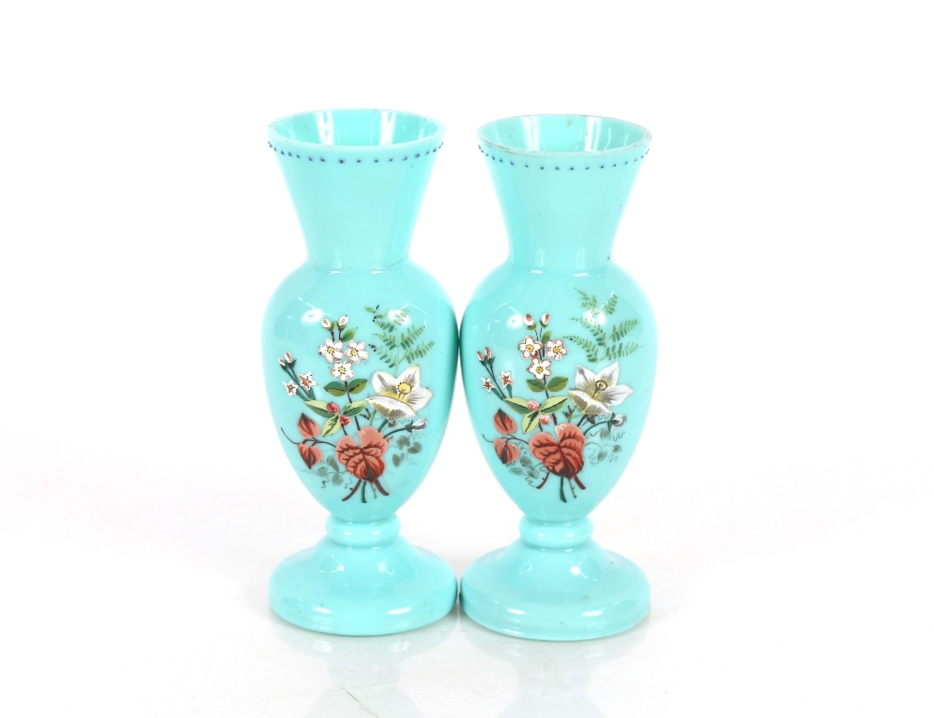 A pair of 19th Century blue opaque glass baluster vases, having enamelled decorated of flowers