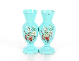 A pair of 19th Century blue opaque glass baluster vases, having enamelled decorated of flowers