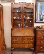 A mid-20th Century walnut bureau bookcase, the upper section enclosed by a pair of glazed panel