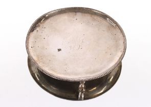 A small Scottish silver card tray, having central monogram, beaded border raised on three hoof feet,