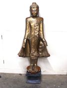 A Chinese red and gilt lacquered figure of a deity, on black wood plinth, 122cm high overall