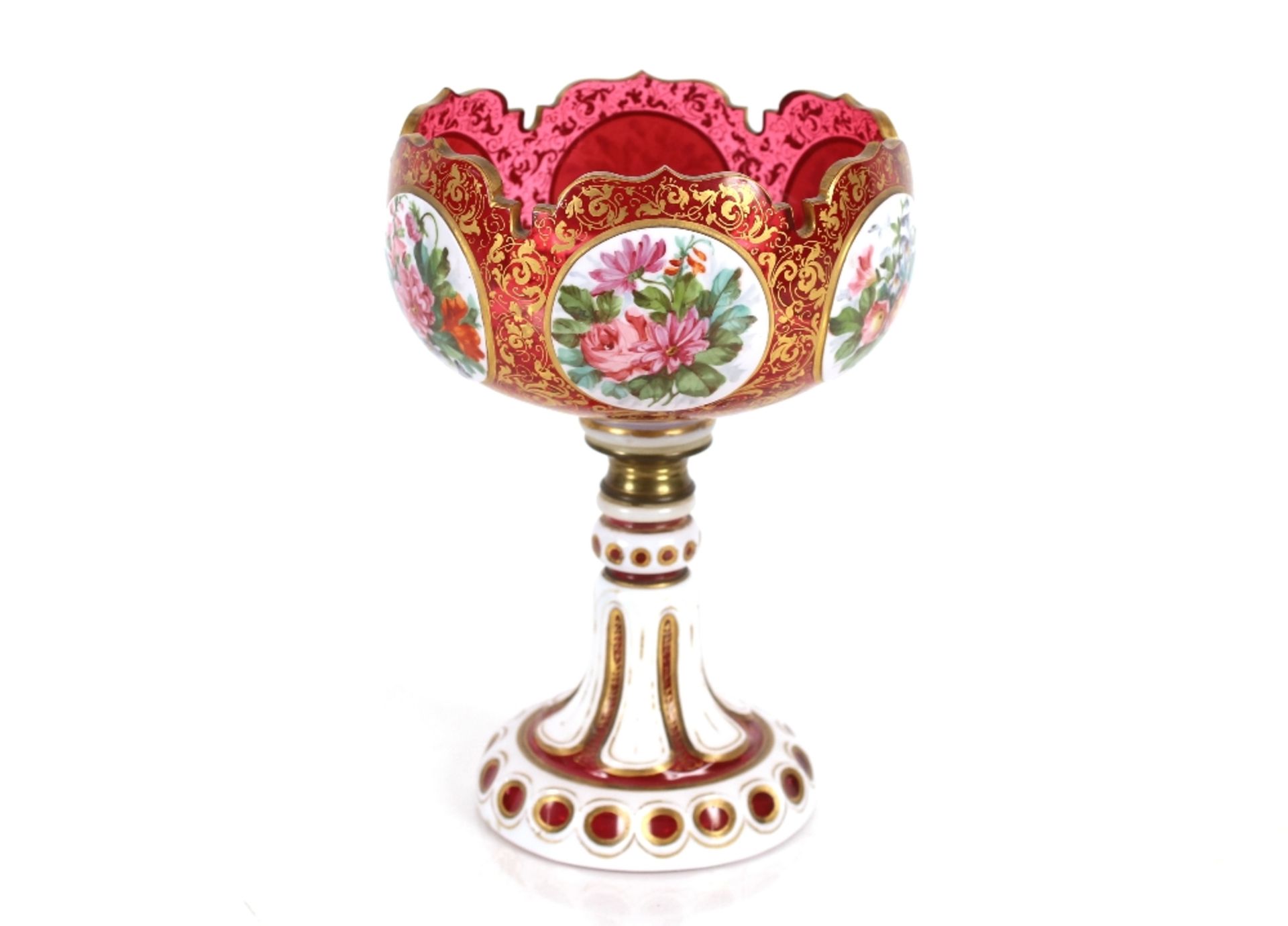 A 19th Century ruby glass overlaid pedestal bowl, the panels with profuse foliate decoration on gilt