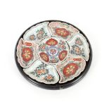 An Imari pattern seven piece hors d'oeuvres set contained in a circular lacquered tray, 34cm dia.
