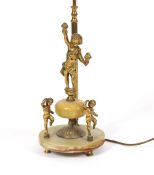An onyx and gilt metal table lamp, with cherub decoration and red silk tasselled shade, 73cm high