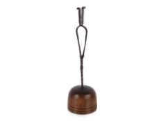 An early 19th Century wrought iron Peerman or pine splint burner, raised on a domed wooden base,