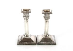 A pair of Victorian silver candlesticks on square