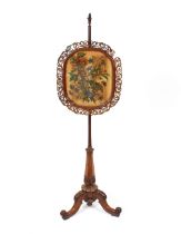 A Victorian rosewood pole screen, having floral decorated banner raised on turned fluted column
