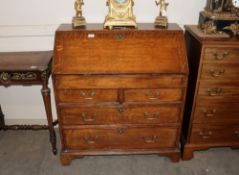 A 19th Century oak bureau, the fitted interior arrangement of drawers and pigeon holes around a