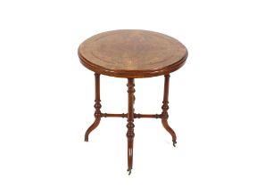 A late Victorian circular walnut and inlaid occasional table, raised on turned columns and out swept