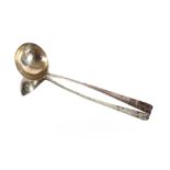 A George III silver soup ladle, with scroll handle decorated monogram and family crest marks
