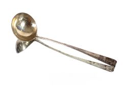 A George III silver soup ladle, with scroll handle decorated monogram and family crest marks