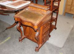 A Victorian walnut Davenport writing desk, of serpentine shape, raised on carved cabriole supports