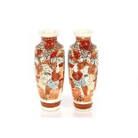 A pair of Japanese baluster Satsuma vases, decorated figures, foliage and scenery on a blue