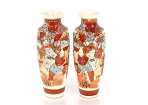 A pair of Japanese baluster Satsuma vases, decorated figures, foliage and scenery on a blue