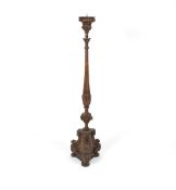 A 19th Century gilt floor standing pricket candlestick, with raised leaf decoration on a turned