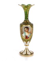 A 19th Century green overlaid glass baluster vase, decorated foliate and portrait panels richly