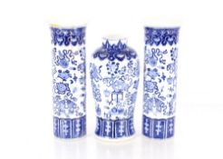 A Chinese blue and white garniture of vases, comprising baluster vase, decorated objects and foliage