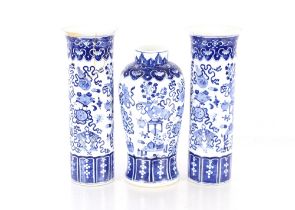 A Chinese blue and white garniture of vases, comprising baluster vase, decorated objects and foliage