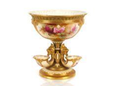 A Royal Worcester table centrepiece decorated with roses within gilt heightened panels, Cornucopia