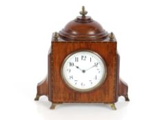 An early 20th Century mahogany and chequer banded mantel timepiece, the case of shaped form