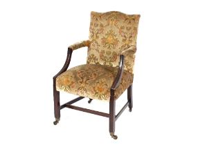 A mahogany Gainsborough style desk chair, upholstered in floral stamped velour, raised on square