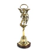 A 19th Century brass cupid door porter on iron base, 45cm high overall