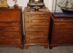 A 19th Century mahogany chest of small proportions, fitted five graduated drawers with brass swan