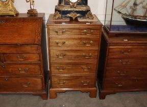 A 19th Century mahogany chest of small proportions, fitted five graduated drawers with brass swan