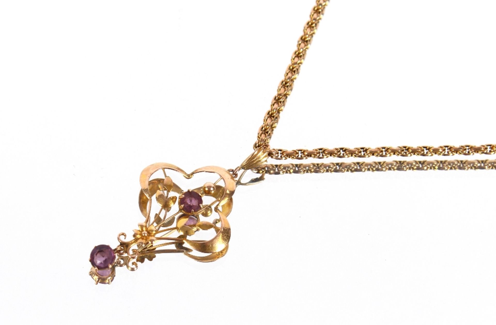 A 9ct gold and amethyst floral pendant hung to a fine 9ct gold chain, 7.5gms total weight