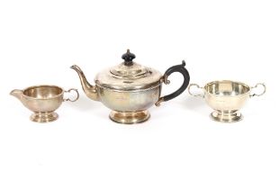 A three piece silver bachelors tea set, having beaded border decoration, Birmingham 1931, the tea