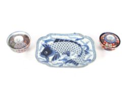 An Imari blue and white fish decorated platter, 31cm; and two Imari covered bowls with six character