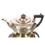 A George III silver cushion shaped tea pot with reeded central band, black wood handle, London 1818,