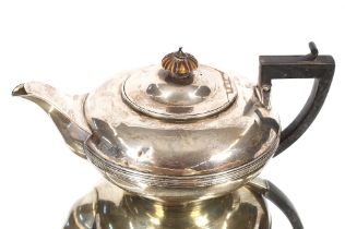 A George III silver cushion shaped tea pot with reeded central band, black wood handle, London 1818,